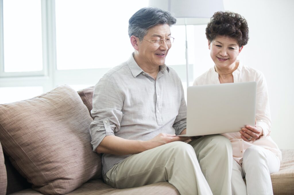 Happy senior couple using laptop